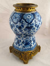 Appraisal: A Dutch delft ceramic lamp base with fitted gilt mount