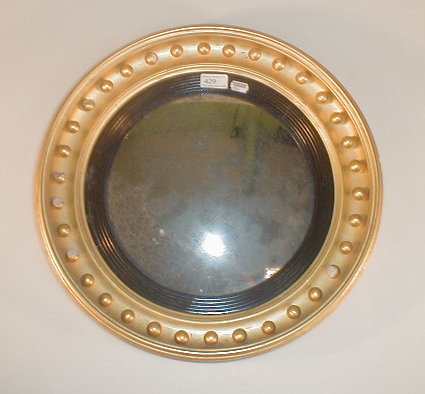 Appraisal: A Regency style circular mirror with a convex glass within