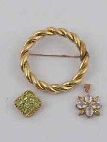 Appraisal: A yellow metal tests ct gold circular brooch together with