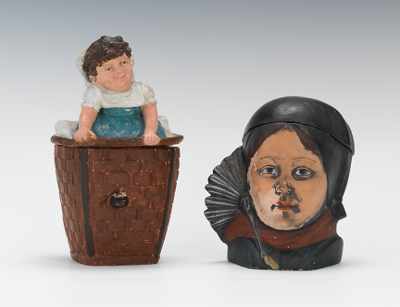 Appraisal: Two Small Tobacco Jars Child in Basket and Sooty Girl