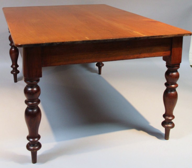 Appraisal: A mahogany kitchen table of large proportion the rounded overhanging