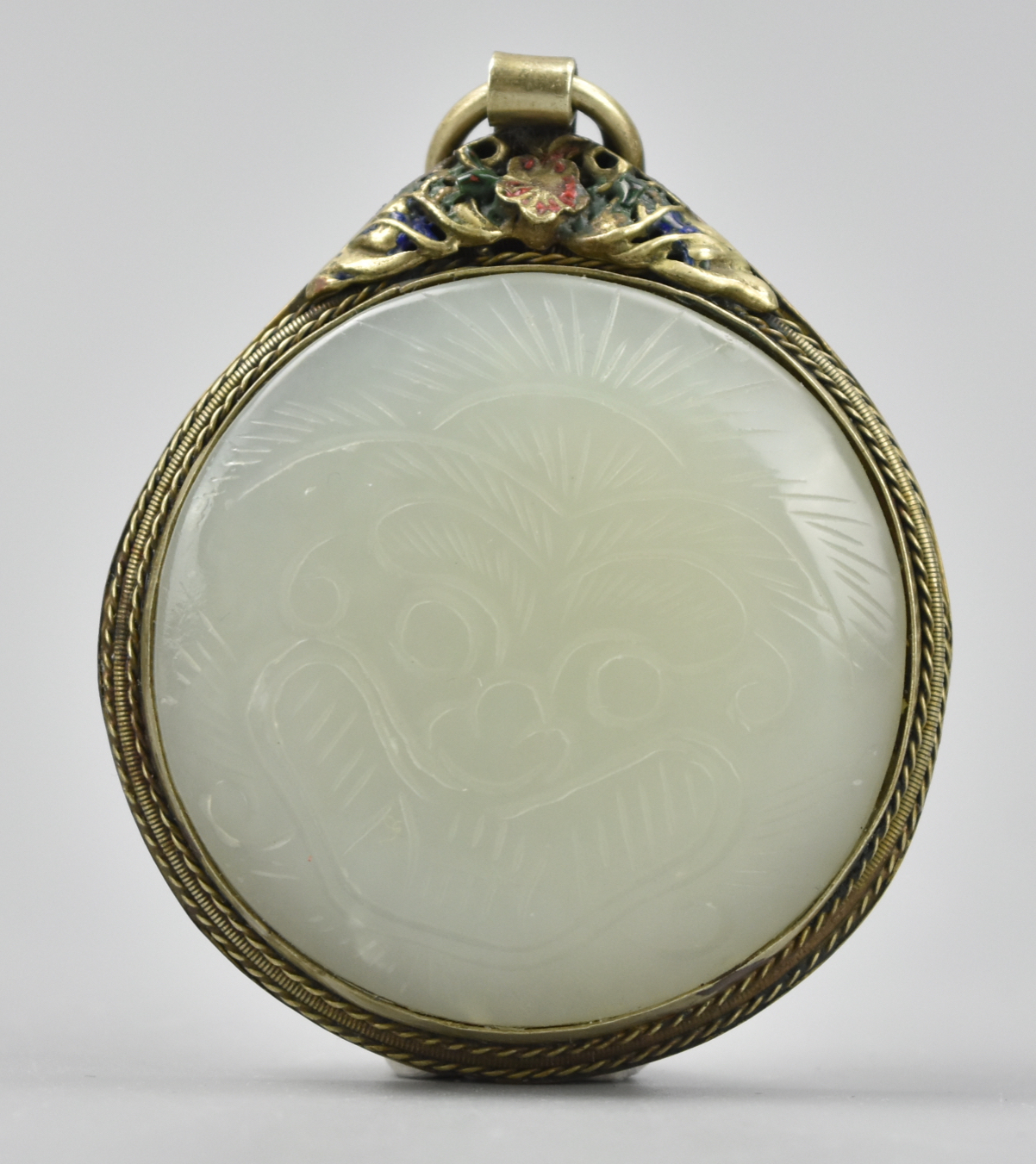 Appraisal: CHINESE CIRCULAR WHITE JADE GUARDIAN LION PENDANT A disc-shaped white