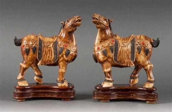 Appraisal: Pair of Chinese carved ivory horses on fitted wood stands