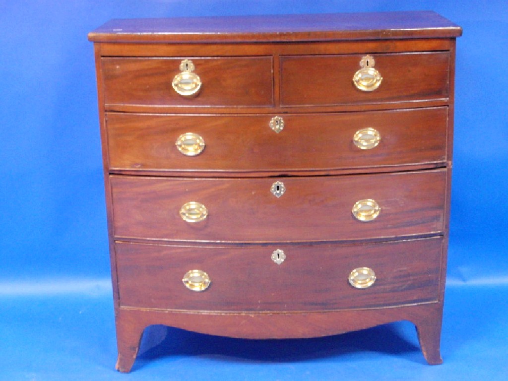 Appraisal: A George III bow fronted mahogany chest of two short