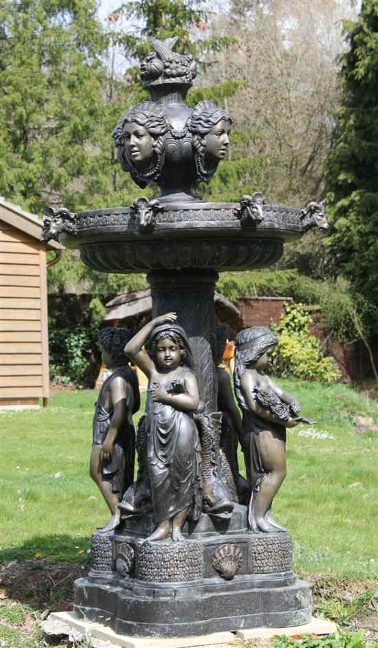 Appraisal: A modern bronze garden fountain with fruiting urn and female