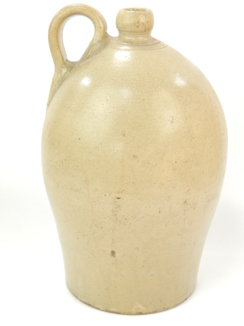 Appraisal: A stoneware flagon of ovoid design with a strap handle