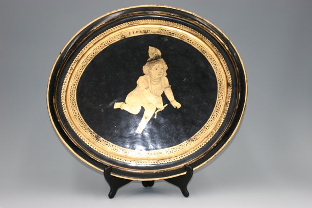 Appraisal: A Burmese oval platter gold on black lacquer decorative platter