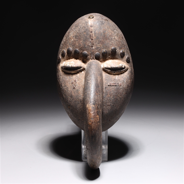 Appraisal: Carved wood African mask with metal accents from the Ivory