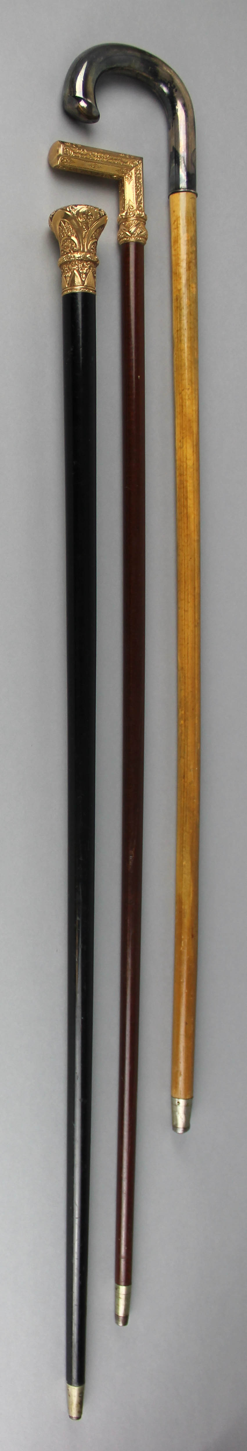 Appraisal: THREE WOOD WALKING STICKS WITH METAL HANDLES the first Swedish