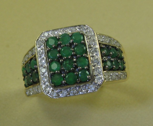 Appraisal: EMERALD AND FOURTEEN KARAT GOLD RING set with round-cut green