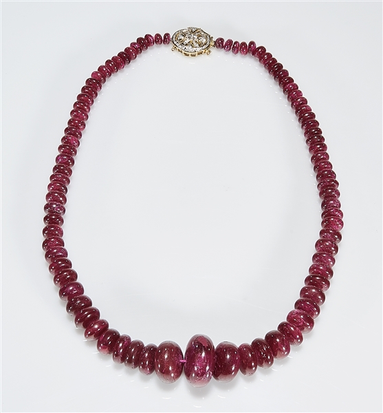 Appraisal: African dyed ruby bead necklace k gold and diamond pendant