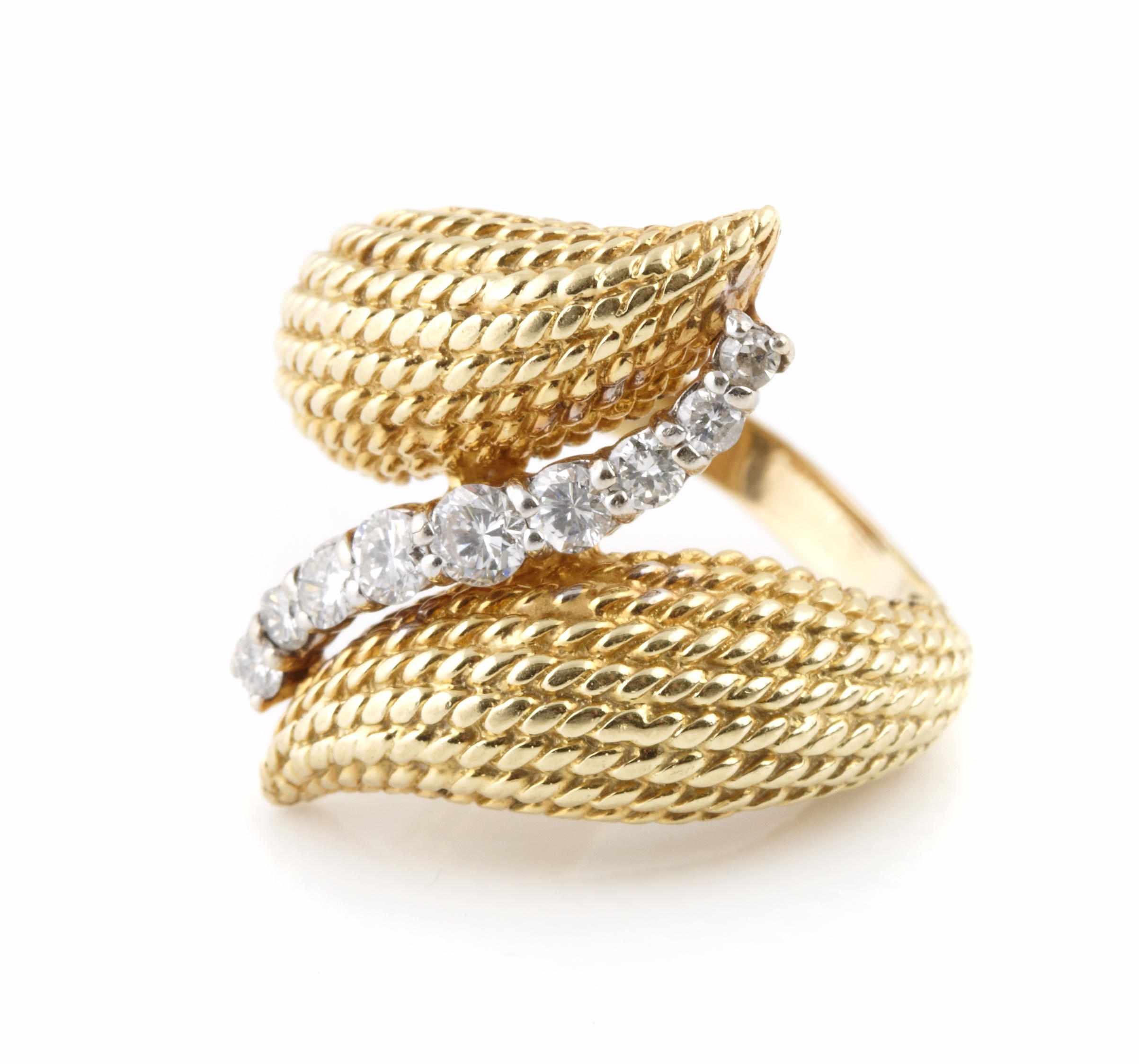 Appraisal: A diamond and bicolor gold bypass ring size