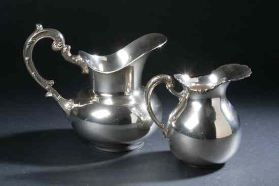 Appraisal: TWO PERUVIAN STERLING SILVER WATER PITCHERS The smaller San Agustin