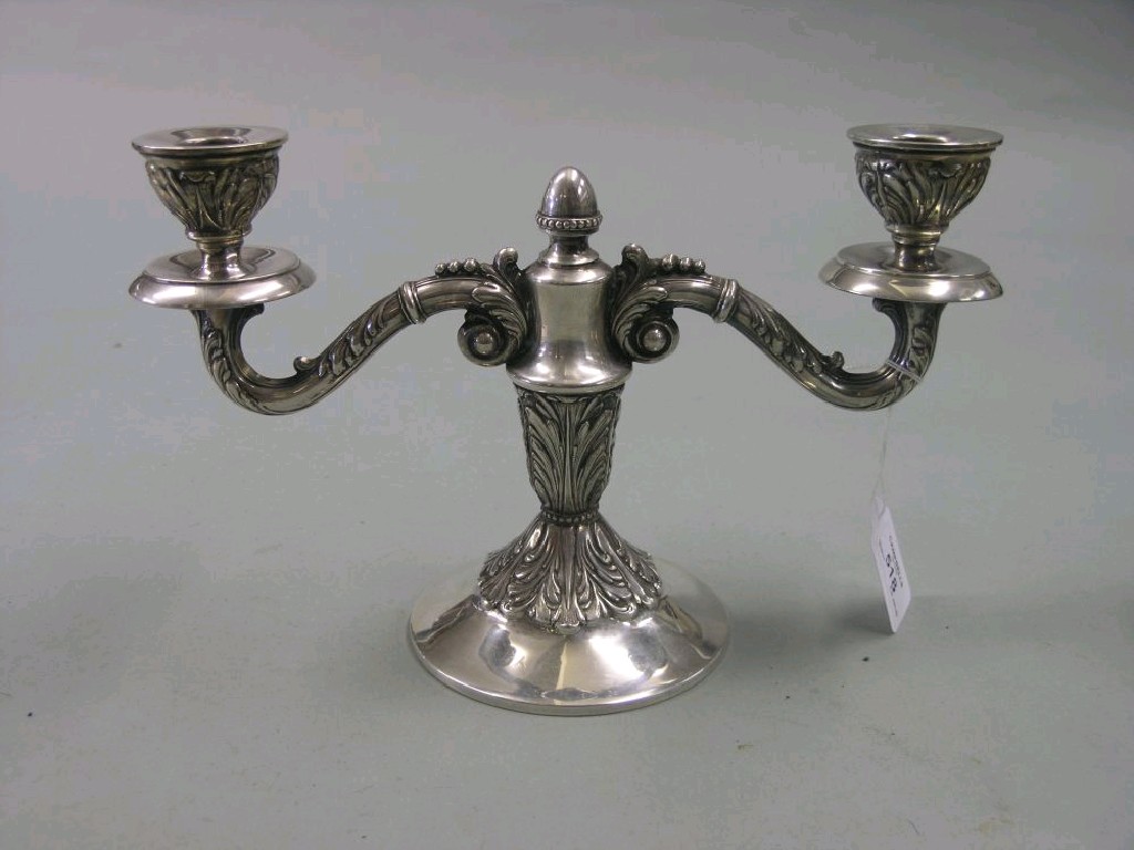 Appraisal: A white metal candelabra twin sconces on scroll arms acanthus