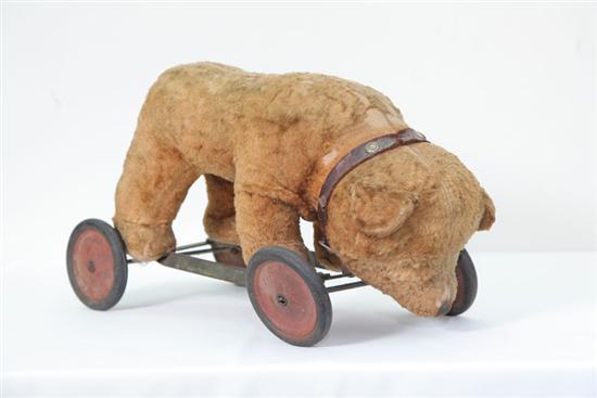 Appraisal: STUFFED RIDING BEAR ON WHEELS Possibly Steiff Having a leather