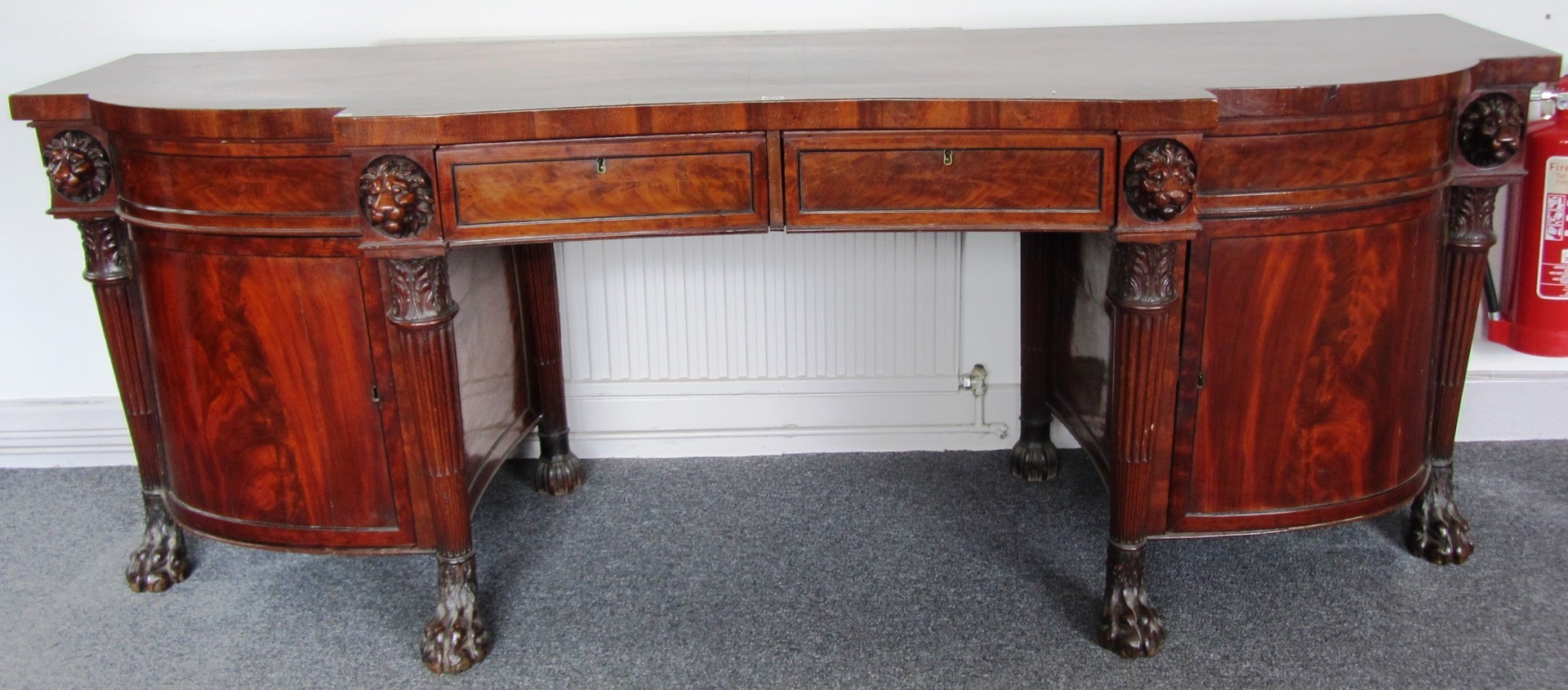 Appraisal: A Regency mahogany concave fronted sideboard with an arrangement of