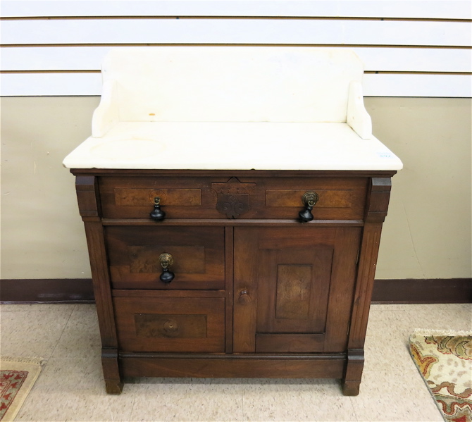 Appraisal: VICTORIAN MARBLE-TOP WALNUT WASHSTAND COMMODE American c having a rectangular