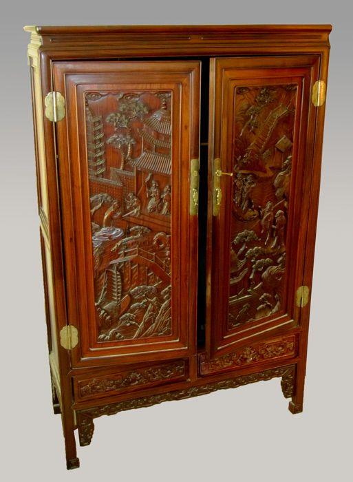 Appraisal: CHINESE ROSEWOOD CABINET High relief carvings to doors drawer fronts