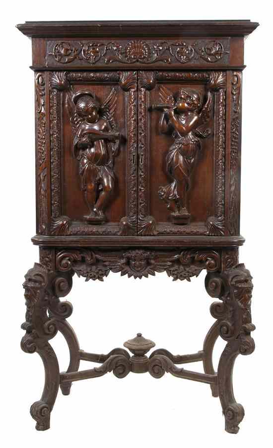 Appraisal: A Continental Carved Cabinet on Stand the foliate cast frieze