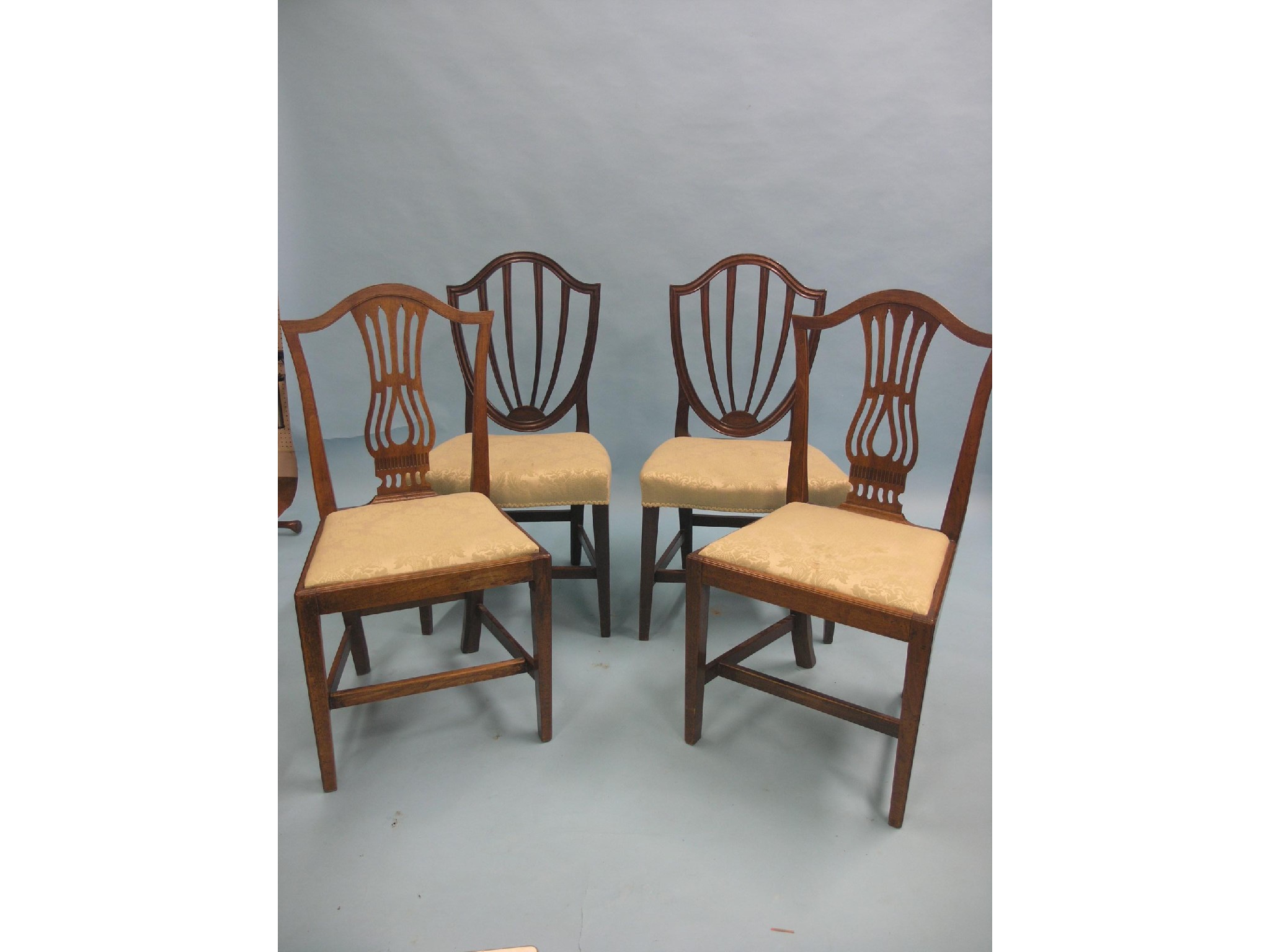 Appraisal: Two pairs of Hepplewhite-period mahogany dining chairs camel-backs and matching