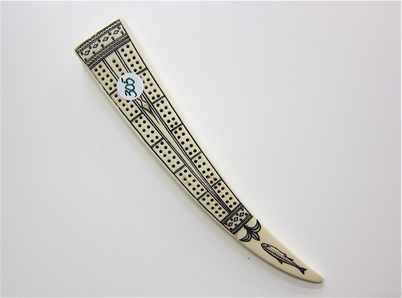 Appraisal: SCRIMSHAW WALRUS IVORY TUSK CRIBBAGE BOARD decorated with fish and