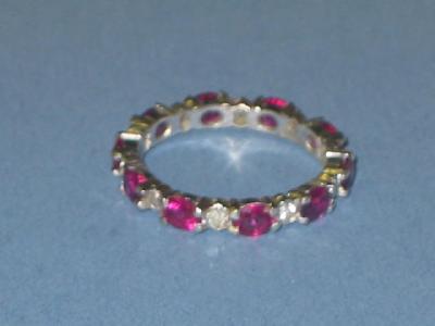 Appraisal: A RUBY AND DIAMOND ETERNITY RING comprising alternate diamonds and