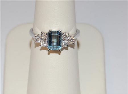 Appraisal: An aquamarine and diamond cluster ring corner claw set to