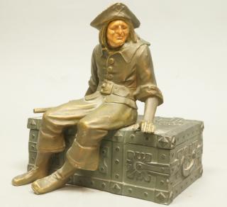 Appraisal: Cast Metal Hinged Box Seated Pirate with Carved Face Not