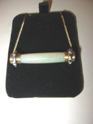 Appraisal: AN OPAL AND DIAMOND PENDANT the cylindrical polished opal diamond