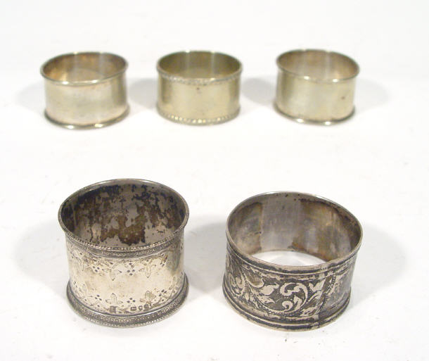 Appraisal: Two silver napkin rings with chased leaf decoration together with