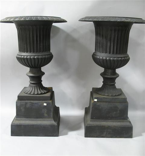 Appraisal: PAIR OF LARGE BLACK PAINTED URNS WITH BASES Covered in