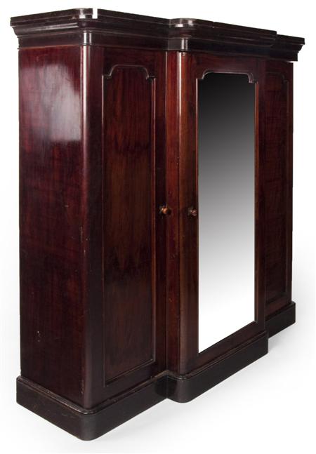 Appraisal: A Victorian mahogany breakfront wardrobe the projected moulded cornice over