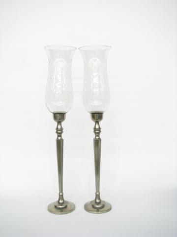 Appraisal: Pair of tall metal candlesticks with glass hurricane shades overall