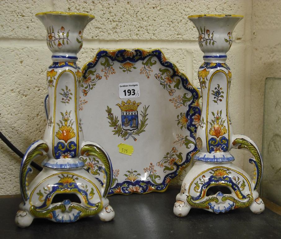 Appraisal: Pair of French faience glazed candlesticks painted with floral motifs