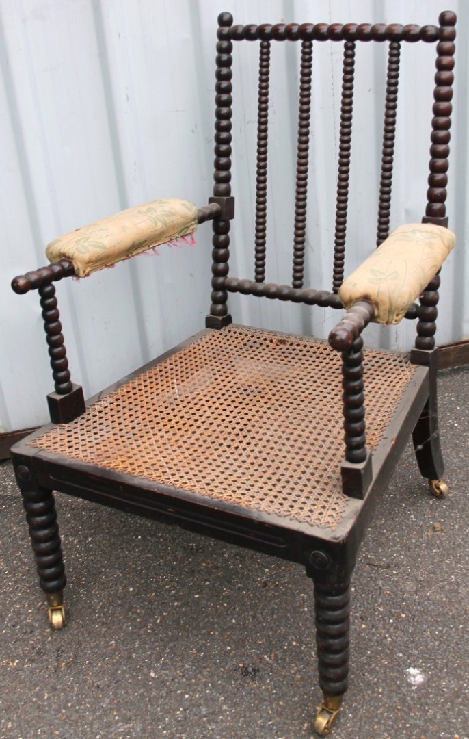 Appraisal: A thC polished walnut bobbin turned open armchair with upholstered