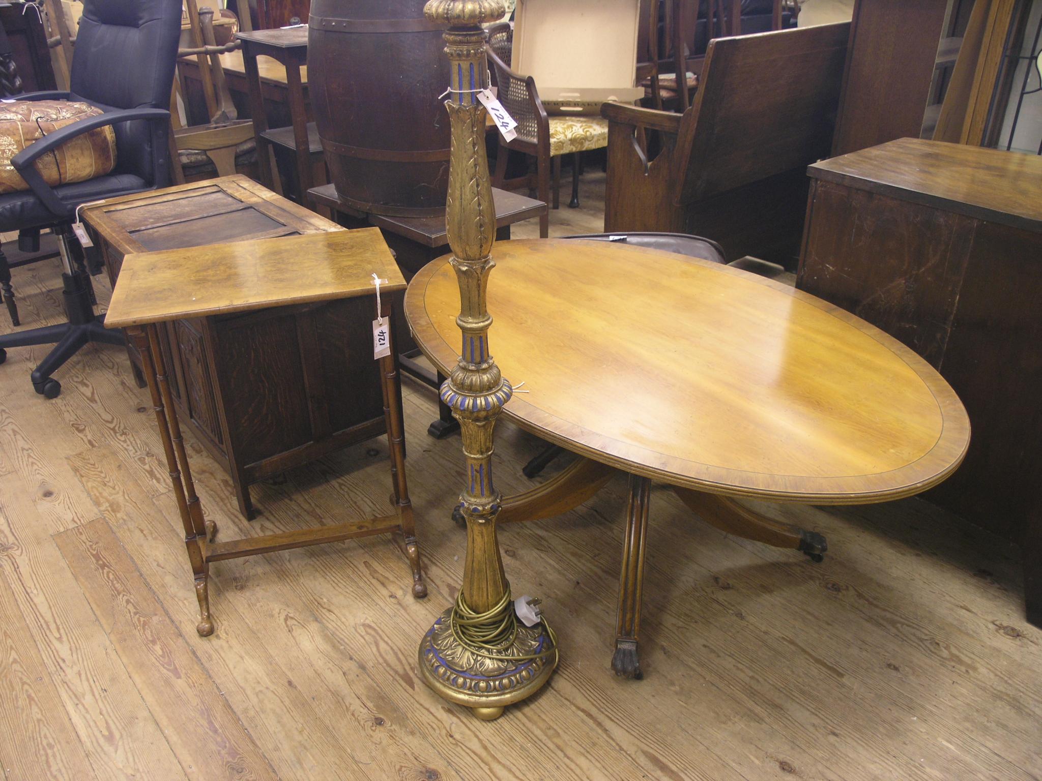 Appraisal: A reproduction mahogany coffee table long oval top ft in