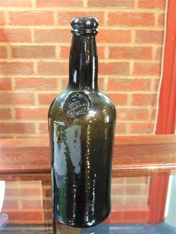 Appraisal: A SMALL GREEN WINE BOTTLE with applied Middle Temple seal