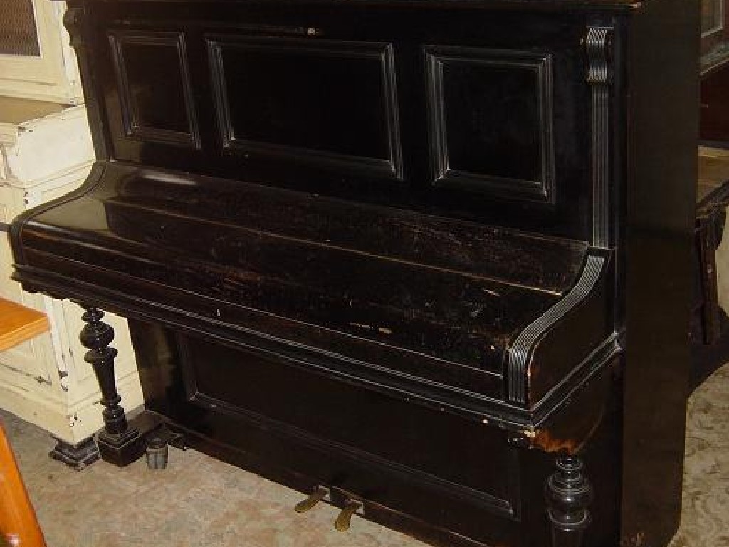 Appraisal: A German upright iron framed and overstrung piano in ebonised