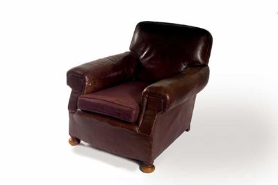 Appraisal: A leather upholstered easy armchair on turned bun feet early