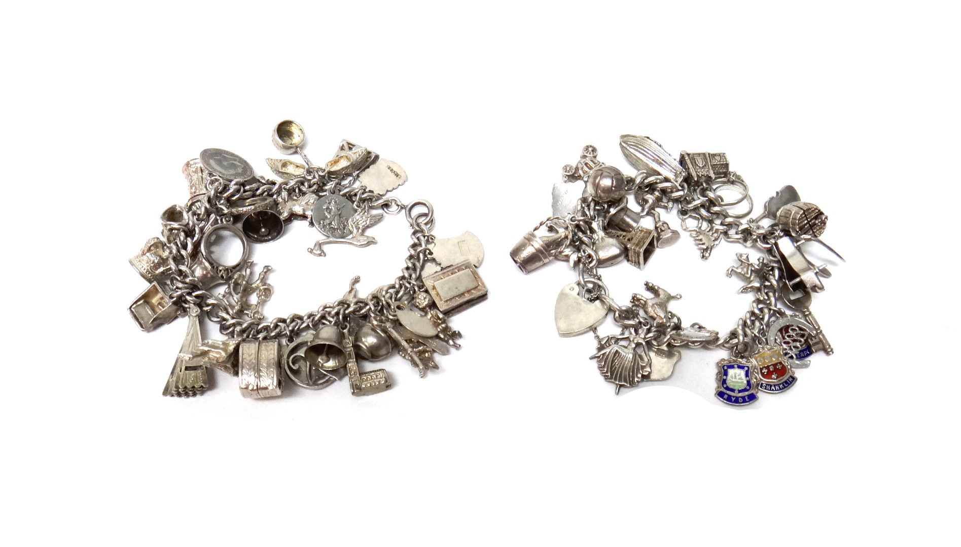 Appraisal: Two silver curb link charm bracelets each fitted with a