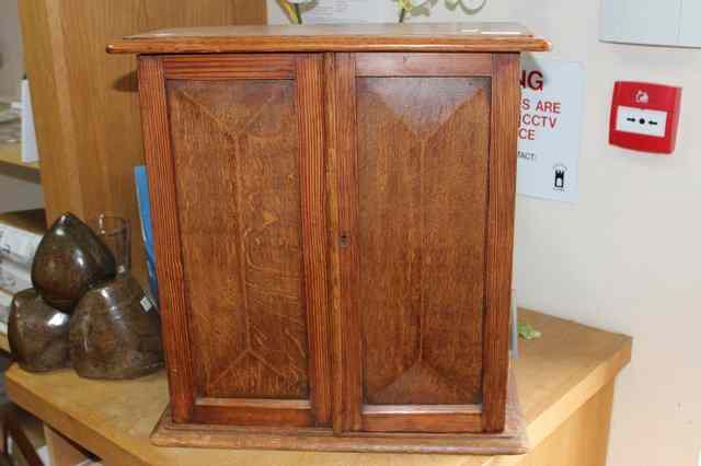 Appraisal: A PITCH PINE AND OAK TABLE CABINET the twin fielded