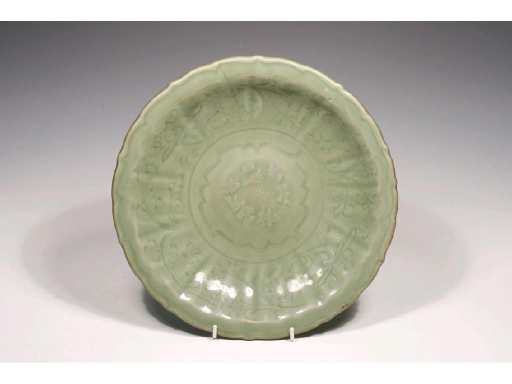 Appraisal: A CHINESE CELADON DISH moulded with flowers and leafy scrolls