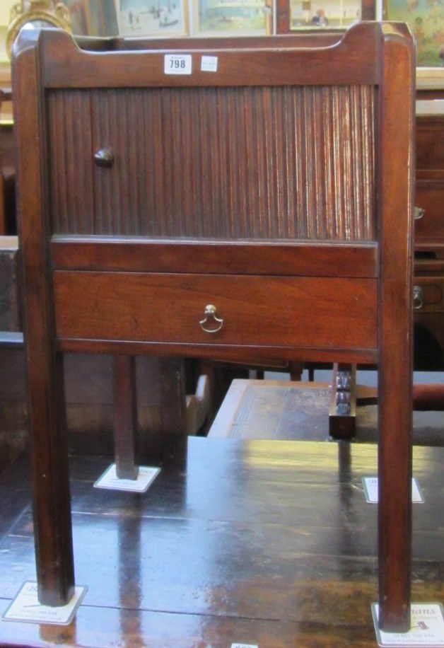 Appraisal: An th century tray top mahogany commode with tambour panel