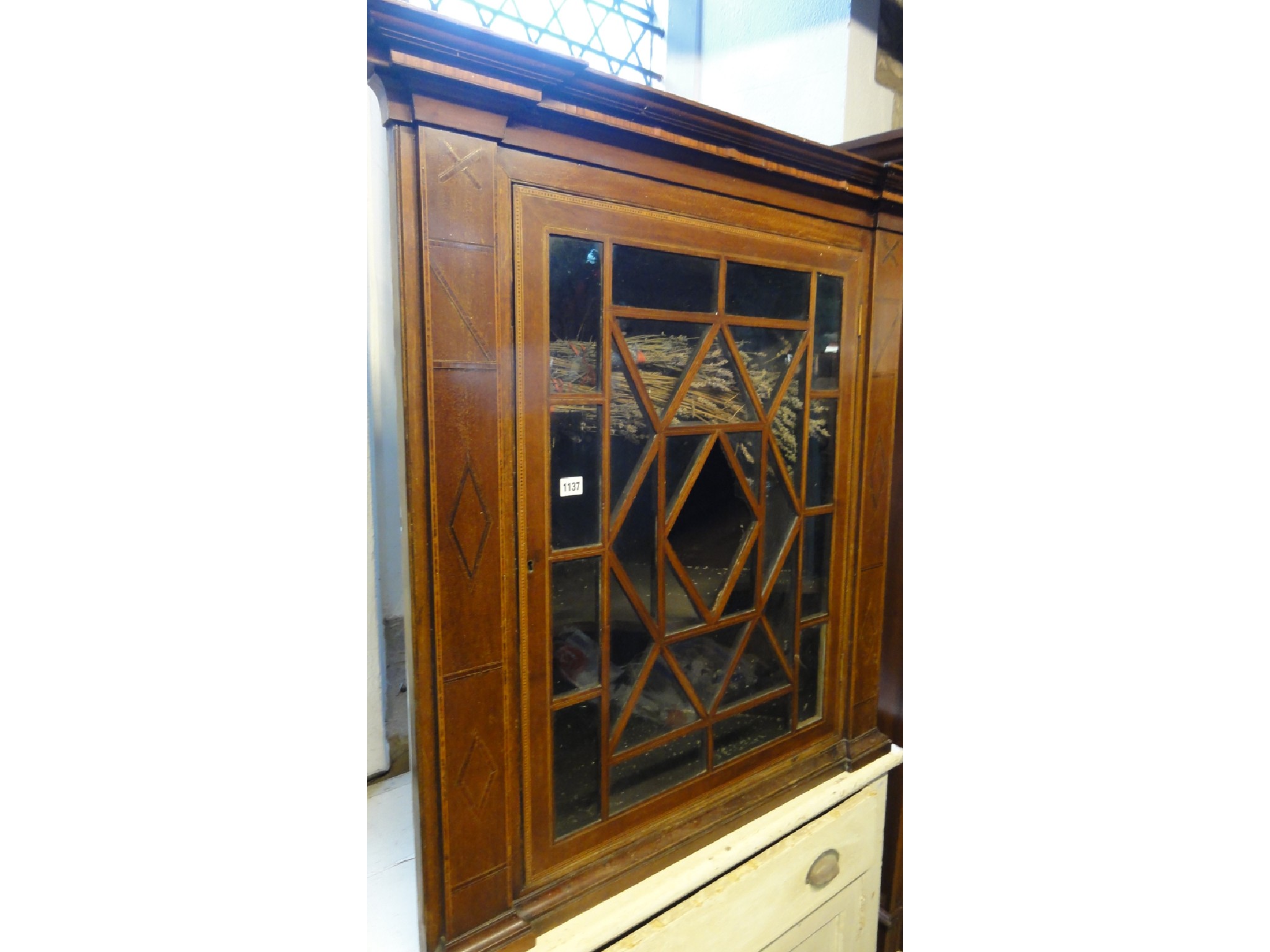 Appraisal: A th century mahogany hanging corner cabinet with satinwood banding