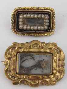 Appraisal: A gilt metal and enamel mourning brooch with pearl set