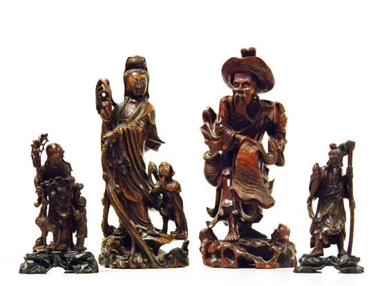 Appraisal: Four Asian wooden figures including elderly male figure with small