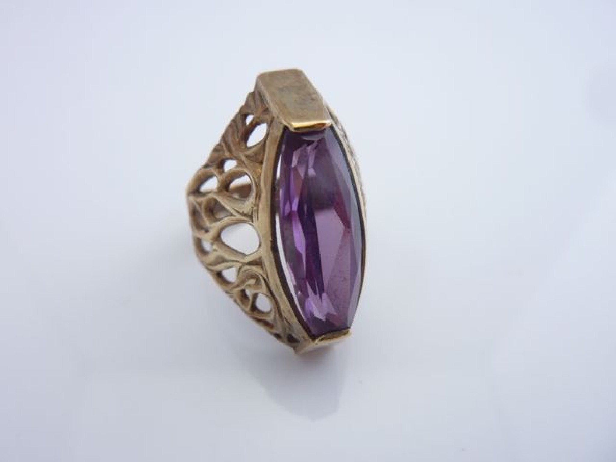 Appraisal: A synthetic alexandrite dress ring with openworked scrolling shoulders in