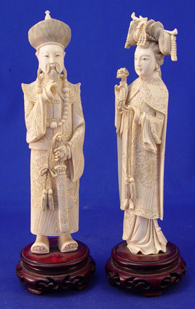 Appraisal: TWO CARVED IVORY CHINESE FIGURES Man and woman Man in