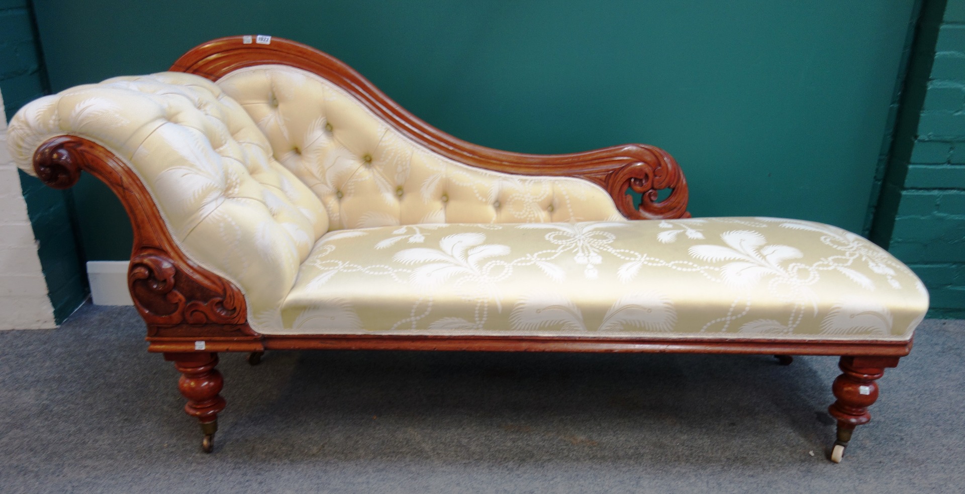 Appraisal: A Victorian walnut scroll end chaise longue on turned supports