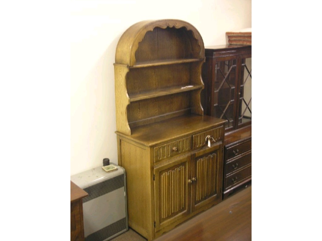 Appraisal: A dark oak dresser domed plate rack with two shelves